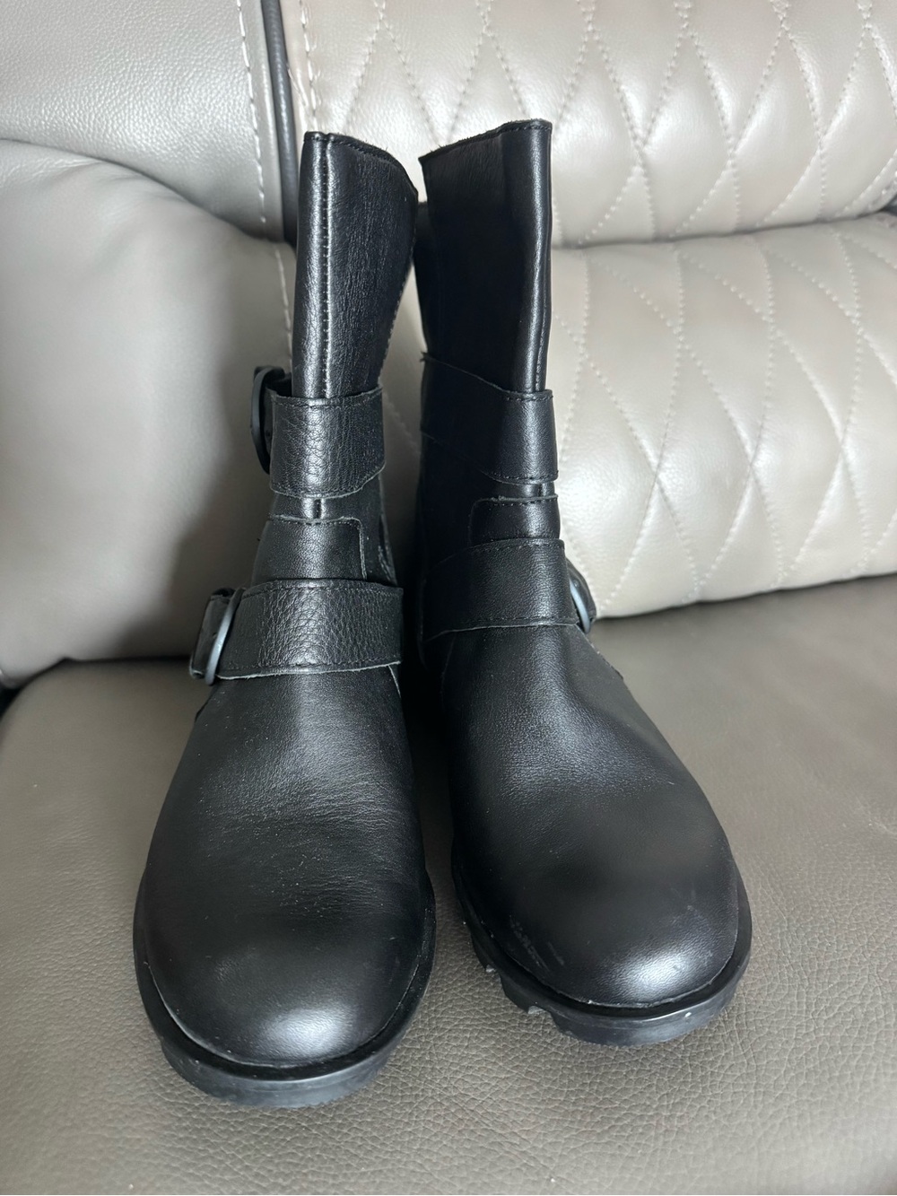 Sorel Phoenix Moto boots in black leather, featuring distinct edgy buckle